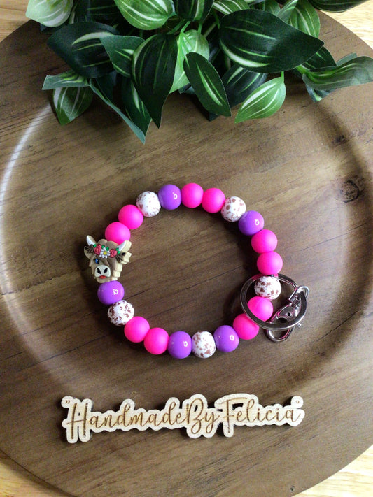 Pink and purple cow wristlet