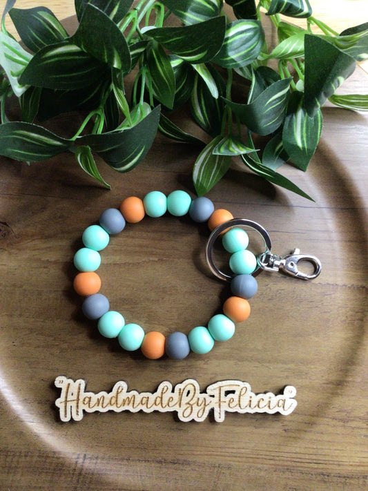Rustic orange, grey and mint wristlet
