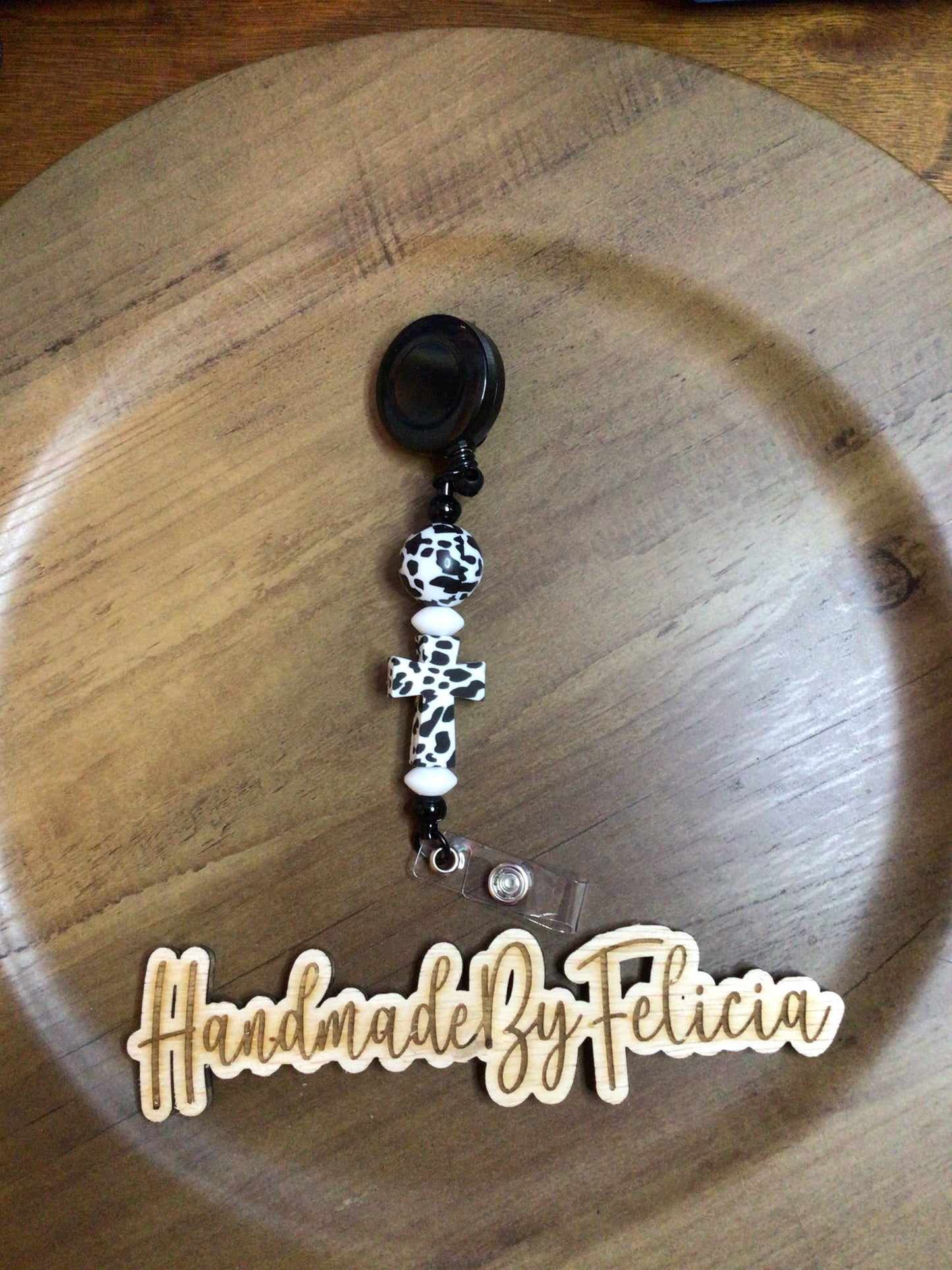 Black cross cow print badge reel