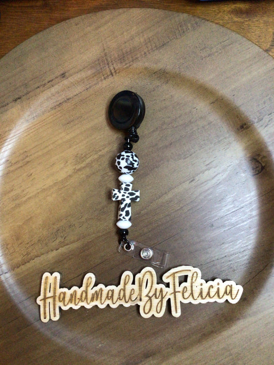 Black cross cow print badge reel
