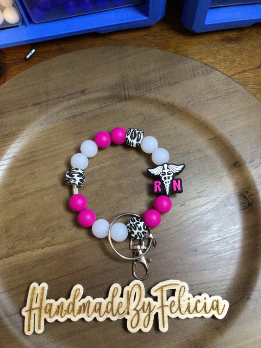 Pink RN wristlet with glow white beads
