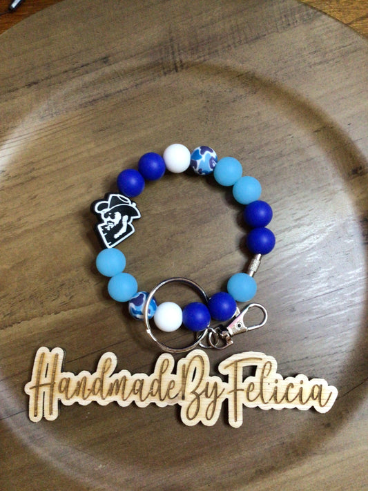 Blue wristlet with cowboy