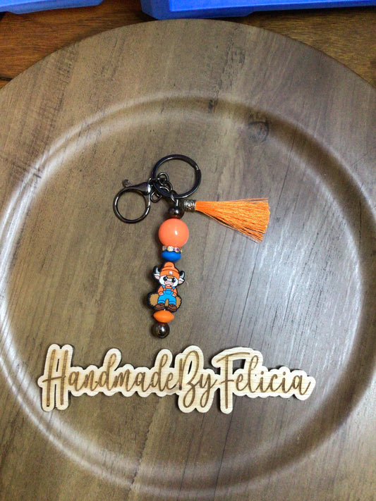 Orange hat cow keychain