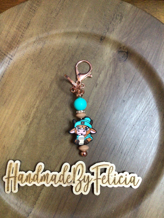 Teal cow with drink keychain
