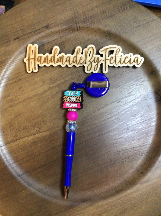 Blue teacher badge reel with pen