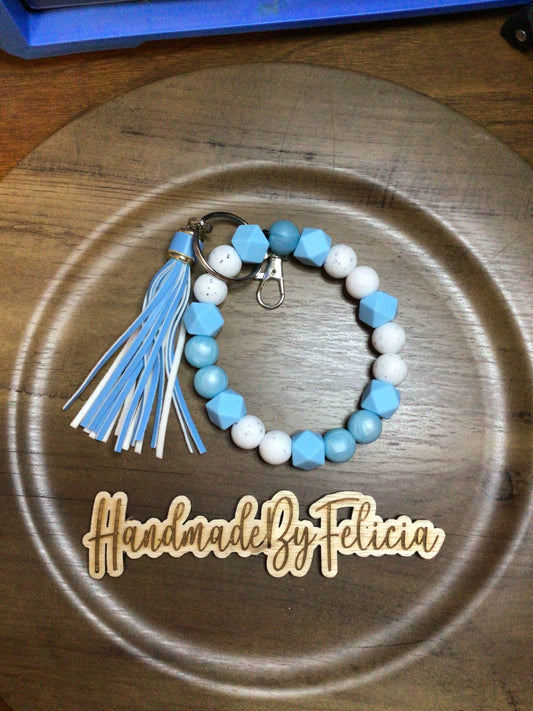 Light blue and white wristlet with tassel