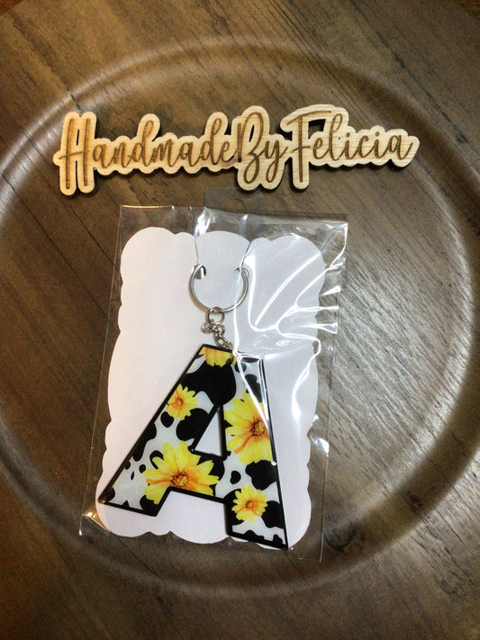 Letter A sunflower black cow acrylic keychain