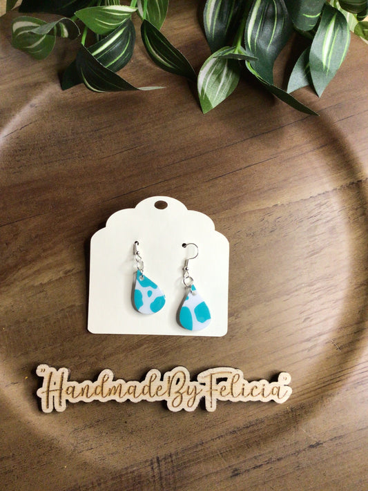 Teal cow print acrylic earrings