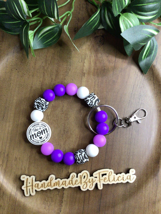 She is mom purple wristlet