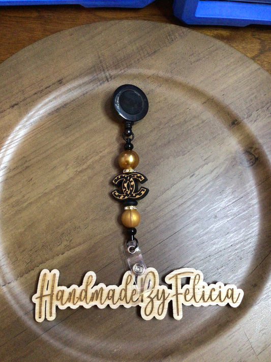 Gold C C badge reel