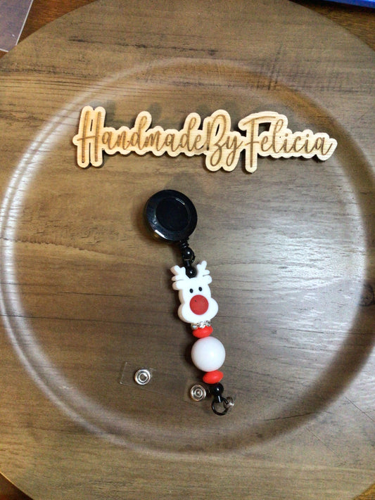 White reindeer badge reel on black